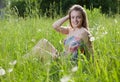 Happy girl sitting in a grass