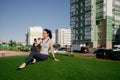 A happy girl is sitting on the green grass in the yard of her house Royalty Free Stock Photo