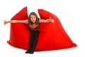 Happy girl sitting on red beanbag sofa for living room or other Royalty Free Stock Photo