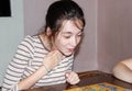 A happy Girl is sitting at a table in a room and playing a Board game Royalty Free Stock Photo