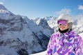 Happy girl in ski helmet and mask over mountain Royalty Free Stock Photo