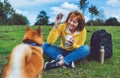 Happy girl with smile drink cup playing with red japanese dog shiba inu on green grass in the outdoors nature park, beautiful Royalty Free Stock Photo