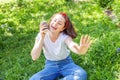 Happy girl smiling outdoor having lunch break. Beautiful young brunete woman with take away coffee cup resting on park or garden Royalty Free Stock Photo