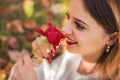 Girl sniffing a red rose