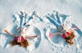 Happy girl on a snow angel shows. Two little girl making snow angel while lying on snow.