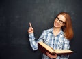 Happy girl student with glasses and book from blank blackboard Royalty Free Stock Photo