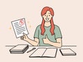 Happy girl student rejoices at average mark for test sits at table with books and pen