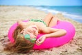 Happy girl sunbathing on beach