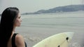 Happy girl surfer running laughing cheerful having fun with surfing boogieboard on summer holidays