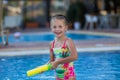 Happy Girl in swimwear shooting up with water gun Royalty Free Stock Photo