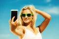 Happy girl taking self picture with smartphone Royalty Free Stock Photo