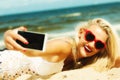 Happy girl taking self picture with smartphone Royalty Free Stock Photo