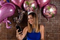 Joyful Birthday Celebration: Beautiful Woman Captures the Moment with a Selfie Royalty Free Stock Photo