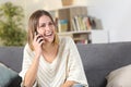 Happy girl talking on mobile phone at home Royalty Free Stock Photo