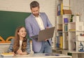 happy girl with teacher in classroom use laptop Royalty Free Stock Photo