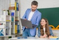 happy girl with teacher in classroom use laptop Royalty Free Stock Photo