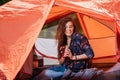 Happy girl in tent with thermos bottle Royalty Free Stock Photo