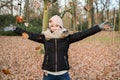 A happy girl throwing leaves in the coming of autumn Royalty Free Stock Photo