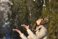 Happy girl throwing snow in the air on winter holdays Royalty Free Stock Photo