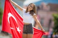 Happy girl tourist walking in the street with turkey flag