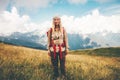 Happy girl Traveler with backpack hiking at mountains