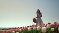 Happy girl turning around in tulips garden.Creative young woman enjoying flowers Royalty Free Stock Photo