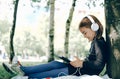 Happy girl using digital tablet in the park