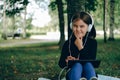 Happy girl using digital tablet in the park