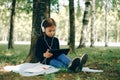 Happy girl using digital tablet in the park