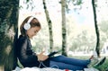 Happy girl using digital tablet in the park