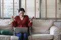 Happy girl using a laptop and smart phone. Happy young woman using phone, browsing mobile device app, playing game Royalty Free Stock Photo