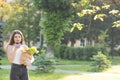 Happy girl using a smart phone voice recognition audio ai message speech function on line walking on a park background Royalty Free Stock Photo