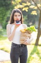 Happy girl using a smart phone voice recognition audio ai message speech function on line walking on a park background Royalty Free Stock Photo