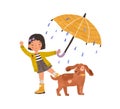 Happy girl walking with cute dog under umbrella, enjoying rain. Kid in gumboots playing or dancing outdoor in rainy Royalty Free Stock Photo