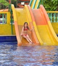 Happy girl on water slide Royalty Free Stock Photo