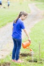 Happy Girl watering plants Outdoors