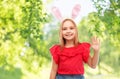 Happy girl wearing easter bunny ears waving hand Royalty Free Stock Photo
