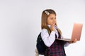 Happy girl wearing uniform, holding a laptop computer, show hello, isolated on gray background. Onlinelearning concept.