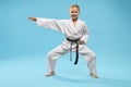 Happy girl in white kimono standing in universal stance Royalty Free Stock Photo