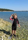 Happy girl with wetsuit, masks and snorkels at the s Royalty Free Stock Photo