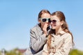 Happy girl whispering secret to her friends ear Royalty Free Stock Photo