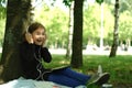 Happy girl using digital tablet in the park