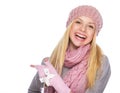 Happy girl in winter clothes pointing on copy space Royalty Free Stock Photo