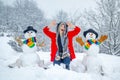 Happy girl winter portrait. Happy snowman standing in winter Christmas landscape. Winter woman in frosty winter Park. Royalty Free Stock Photo