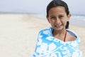 Happy Girl Wrapped In Towel Standing At Beach