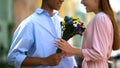 Happy girlfriend receiving bouquet of beautiful flowers from her boyfriend, love Royalty Free Stock Photo