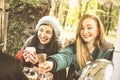 Happy girlfriends best friends sharing time together outdoors with coffee Royalty Free Stock Photo