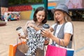 Happy girlfriends looking at new dress bought at shopping mall Royalty Free Stock Photo