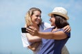 happy girlfriends taking selfie against blue sky Royalty Free Stock Photo