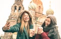 Happy girlfriends taking winter selfie in Saint Petersburg